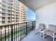 Relaxing balcony with patio chairs; enjoy views of a neighboring building and ocean at 1415 Ocean Shore Blvd # 309, Ormond Beach, FL 32176
