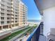 Stunning balcony view of the ocean and neighboring building, creating a serene and appealing outdoor space at 1415 Ocean Shore Blvd # 309, Ormond Beach, FL 32176