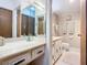 Bathroom with a single sink vanity, toilet, and mirrored medicine cabinet at 1415 Ocean Shore Blvd # 309, Ormond Beach, FL 32176