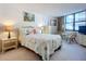 Comfortable bedroom with a beach theme and large windows at 1415 Ocean Shore Blvd # 309, Ormond Beach, FL 32176