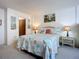 Bright bedroom with beach themed décor, side tables, and lamps at 1415 Ocean Shore Blvd # 309, Ormond Beach, FL 32176