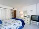 Bedroom featuring decoratively themed bedding and a closet with sliding doors at 1415 Ocean Shore Blvd # 309, Ormond Beach, FL 32176