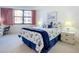 Bedroom with shell-themed bedding and ample natural light at 1415 Ocean Shore Blvd # 309, Ormond Beach, FL 32176