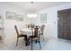The dining room has a round table with 4 chairs, a chandelier, and wall art at 1415 Ocean Shore Blvd # 309, Ormond Beach, FL 32176