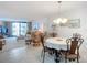 Open floor plan: a living area with slider doors to the balcony and dining area at 1415 Ocean Shore Blvd # 309, Ormond Beach, FL 32176