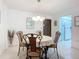 Dining area with a round table, chairs, tiled floor, and chandelier lighting at 1415 Ocean Shore Blvd # 309, Ormond Beach, FL 32176