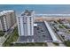Aerial view showing a condo building, parking, and ocean access at 1415 Ocean Shore Blvd # 309, Ormond Beach, FL 32176