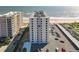 High-rise exterior showing a parking lot and ocean, near another building at 1415 Ocean Shore Blvd # 309, Ormond Beach, FL 32176