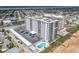 Aerial view of the condo with a pool and a path to the beach at 1415 Ocean Shore Blvd # 309, Ormond Beach, FL 32176