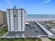 High-rise exterior view showcasing balconies, parking, and an ocean backdrop at 1415 Ocean Shore Blvd # 309, Ormond Beach, FL 32176