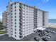 Exterior of high-rise condo building with balconies, parking, and ocean views at 1415 Ocean Shore Blvd # 309, Ormond Beach, FL 32176