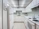 Charming kitchen featuring white appliances and marble countertops at 1415 Ocean Shore Blvd # 309, Ormond Beach, FL 32176