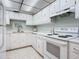 White kitchen showcasing sleek appliances, countertops, and ample cabinet storage at 1415 Ocean Shore Blvd # 309, Ormond Beach, FL 32176