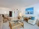 Open living space features comfortable seating, a dining area, and beach-themed decor at 1415 Ocean Shore Blvd # 309, Ormond Beach, FL 32176