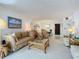 Spacious living room with a dining area, comfortable seating, and a glass coffee table at 1415 Ocean Shore Blvd # 309, Ormond Beach, FL 32176