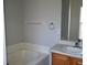 Bathroom with a bathtub, single sink vanity, and towel rack at 1562 Pendleton St, Deltona, FL 32725