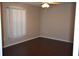 Simple bedroom with dark laminate flooring and window coverings at 1562 Pendleton St, Deltona, FL 32725