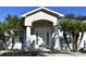 House exterior featuring a white door, arched entryway, and palm trees at 1562 Pendleton St, Deltona, FL 32725