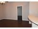 Living room with dark laminate flooring and view into bedroom at 1562 Pendleton St, Deltona, FL 32725