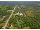 Aerial view of home on large lot with pool and pond at 32200 Ponderosa Ave, Deland, FL 32720