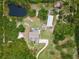 Aerial view showing house, pond, and surrounding land at 32200 Ponderosa Ave, Deland, FL 32720