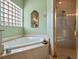 Relaxing bathroom with corner jacuzzi tub and a walk-in shower at 32200 Ponderosa Ave, Deland, FL 32720