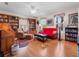 Spacious library with hardwood floors, built-in bookshelves, and a comfortable seating area at 32200 Ponderosa Ave, Deland, FL 32720