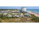 Stunning aerial view capturing the beach, ocean, and the surrounding landscape and neighborhood at 1513 Ocean Shore Blvd # 7B, Ormond Beach, FL 32176