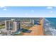 Stunning aerial view of beachfront condos along the Atlantic Ocean, with palm trees, and a sandy beach at 1513 Ocean Shore Blvd # 7B, Ormond Beach, FL 32176