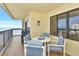 Comfortable outdoor seating on this relaxing balcony overlooking ocean views and a table for dining at 1513 Ocean Shore Blvd # 7B, Ormond Beach, FL 32176