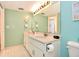 Bright bathroom featuring a dual sink vanity and a modern faucet at 1513 Ocean Shore Blvd # 7B, Ormond Beach, FL 32176