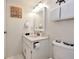Bright bathroom featuring a vanity sink, toilet, and nautical themed decor at 1513 Ocean Shore Blvd # 7B, Ormond Beach, FL 32176