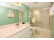 Bathroom featuring a modern sink, vanity, and a shower-tub combo with glass doors at 1513 Ocean Shore Blvd # 7B, Ormond Beach, FL 32176