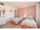 Guest bedroom with charming décor, two beds, dresser, and abundant natural light at 1513 Ocean Shore Blvd # 7B, Ormond Beach, FL 32176