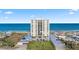 The Ormondy condo building, featuring manicured lawn, landscaping, and convenient parking at 1513 Ocean Shore Blvd # 7B, Ormond Beach, FL 32176