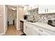 Kitchen featuring stainless steel appliances, stylish backsplash, and ample countertop space at 1513 Ocean Shore Blvd # 7B, Ormond Beach, FL 32176