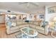 Spacious living room with a large sectional sofa, opening to the kitchen and dining area at 1513 Ocean Shore Blvd # 7B, Ormond Beach, FL 32176