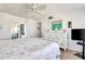 Main bedroom with a king bed, dresser, and a balcony, offering a serene retreat at 1513 Ocean Shore Blvd # 7B, Ormond Beach, FL 32176