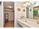 Bathroom vanity area featuring a modern mirror, lighting fixtures, and vanity at 1513 Ocean Shore Blvd # 7B, Ormond Beach, FL 32176