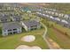 Aerial view of a community featuring lush landscaping, a golf course, and many residential homes at 505 Ocean Course Ave # 505, Davenport, FL 33896