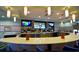 Upscale bar area featuring a long countertop, multiple TVs, and a wide selection of beverages at 505 Ocean Course Ave # 505, Davenport, FL 33896