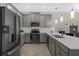Well-lit kitchen with stainless steel appliances, gray cabinets, and white countertops at 505 Ocean Course Ave # 505, Davenport, FL 33896