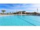 The long pool features clear water, lounge seating, and palm trees for a relaxing experience at 505 Ocean Course Ave # 505, Davenport, FL 33896