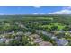 An aerial view of the neighborhood shows mature trees and lush landscaping at 111 Asterbrooke Dr, Deland, FL 32724