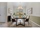 Formal dining room with modern chandelier and neutral decor at 111 Asterbrooke Dr, Deland, FL 32724