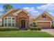 One-story house with stone accents, and a two-car garage at 111 Asterbrooke Dr, Deland, FL 32724