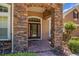 Charming entrance with stone pillar accents and decorative front door at 111 Asterbrooke Dr, Deland, FL 32724
