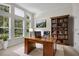 Well-lit office with built-in bookshelf and large windows at 111 Asterbrooke Dr, Deland, FL 32724