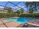 Inviting screened-in pool with a brick patio and fountain feature at 111 Asterbrooke Dr, Deland, FL 32724