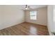 Cozy bedroom with wood floors, ceiling fan, and bright window at 1106 Carvello Dr, The Villages, FL 32162
